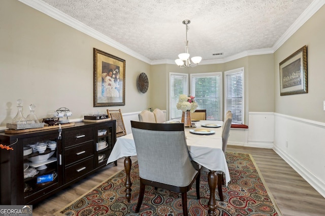 135 Clubhouse Dr NW, Kennesaw, GA 30144 - dining area featuring a chandelier, wood finished floors, a textured ceiling, and crown molding