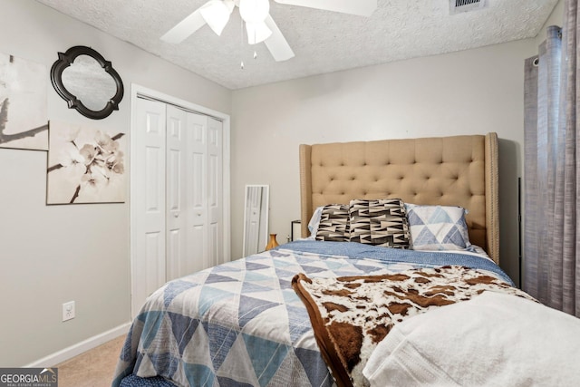 135 Clubhouse Dr NW, Kennesaw, GA 30144 - carpeted bedroom featuring a closet, baseboards, ceiling fan, and a textured ceiling