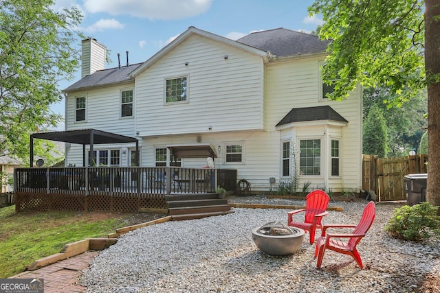 135 Clubhouse Dr NW, Kennesaw, GA 30144 - rear view of house featuring a fire pit, a chimney, a wooden deck, and a shingled roof
