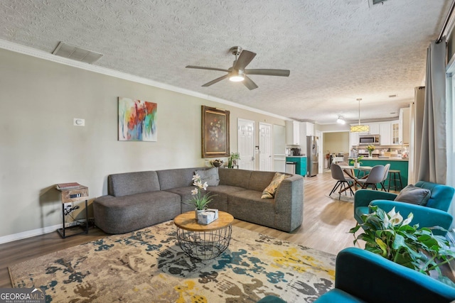 135 Clubhouse Dr NW, Kennesaw, GA 30144 - living area featuring light wood-type flooring, ceiling fan, ornamental molding, a textured ceiling, and baseboards
