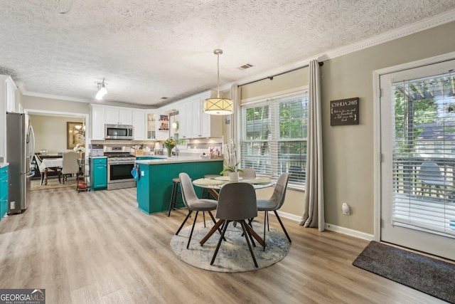 135 Clubhouse Dr NW, Kennesaw, GA 30144 - dining space with ornamental molding, light wood-style floors, a textured ceiling, and baseboards