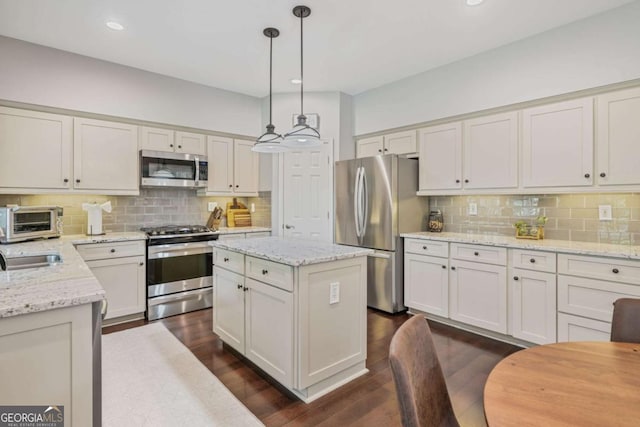 8045 Depford Way, Cumming, GA 30041 - kitchen featuring stainless steel appliances, tasteful backsplash, dark wood-style flooring, light stone countertops, and recessed lighting