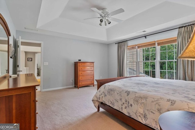 8045 Depford Way, Cumming, GA 30041 - bedroom featuring a tray ceiling, light carpet, a ceiling fan, and baseboards