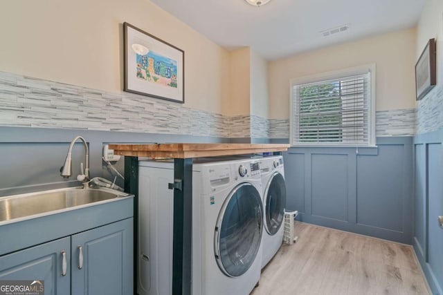 8045 Depford Way, Cumming, GA 30041 - laundry room featuring washer and clothes dryer, wainscoting, a sink, and light wood-style floors