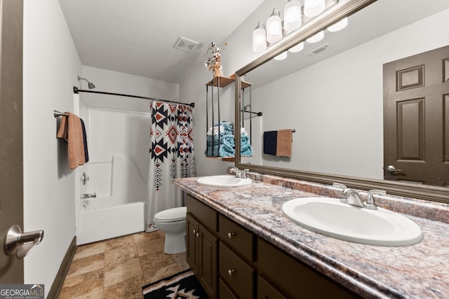 5995 Wellington Ave, Gainesville, GA 30506 - bathroom featuring toilet, double vanity, stone finish flooring, shower / bathtub combination with curtain, and baseboards