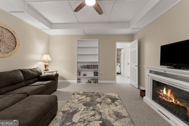 5995 Wellington Ave, Gainesville, GA 30506 - carpeted living room with a ceiling fan, baseboards, and a lit fireplace
