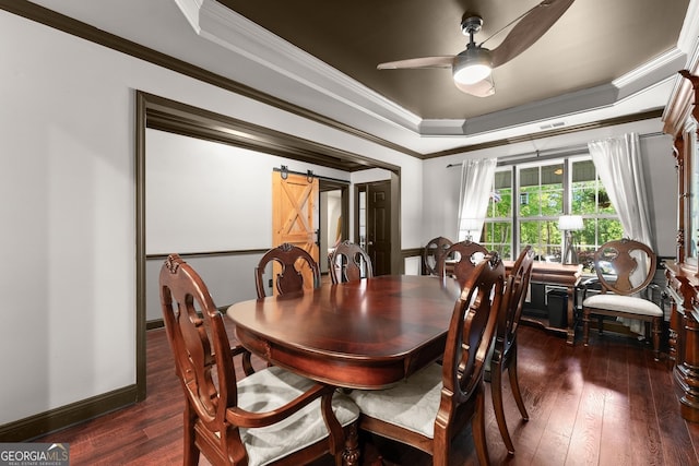 5995 Wellington Ave, Gainesville, GA 30506 - dining area featuring a barn door, dark wood finished floors, a ceiling fan, a raised ceiling, and crown molding