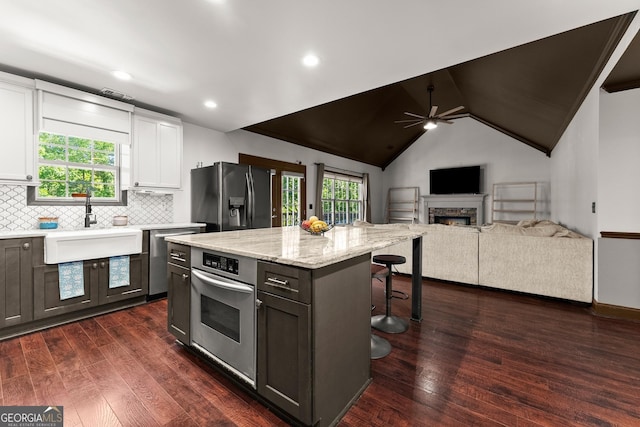 5995 Wellington Ave, Gainesville, GA 30506 - kitchen with appliances with stainless steel finishes, a kitchen breakfast bar, white cabinetry, a sink, and a ceiling fan