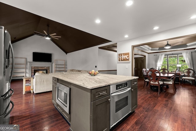 5995 Wellington Ave, Gainesville, GA 30506 - kitchen featuring ceiling fan, stainless steel appliances, a lit fireplace, light stone countertops, and recessed lighting
