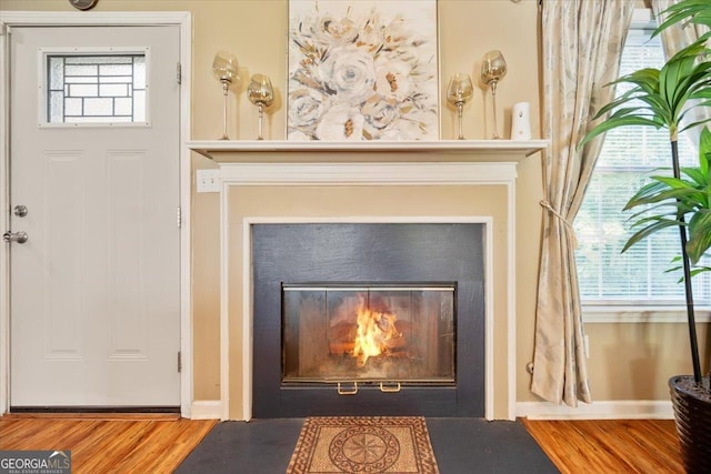 160 Country Mill Ln, Stockbridge, GA 30281 - detailed view of a fireplace with flush hearth, wood finished floors, and baseboards
