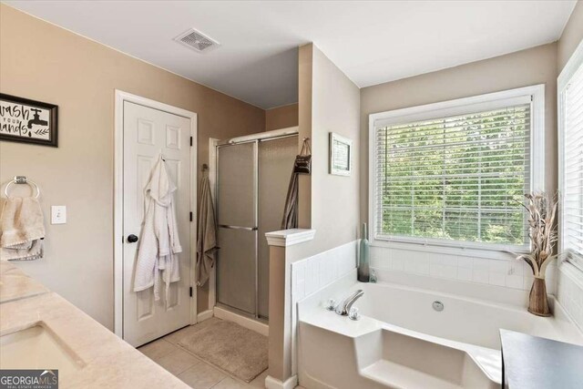 242 Sandhurst Ct, Suwanee, GA 30024 - bathroom featuring a bath, a stall shower, double vanity, and tile patterned floors
