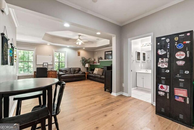 242 Sandhurst Ct, Suwanee, GA 30024 - living room with light wood finished floors, ornamental molding, ceiling fan, a raised ceiling, and recessed lighting