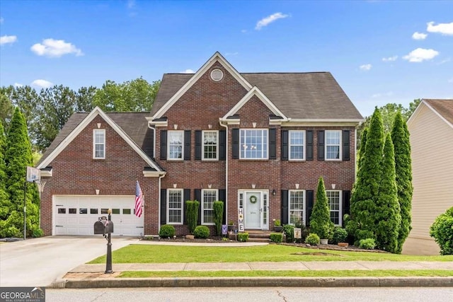 242 Sandhurst Ct, Suwanee, GA 30024 - colonial-style house with brick siding, concrete driveway, a front lawn, and an attached garage