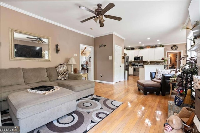 242 Sandhurst Ct, Suwanee, GA 30024 - living room with ceiling fan, light wood-type flooring, crown molding, stairs, and baseboards
