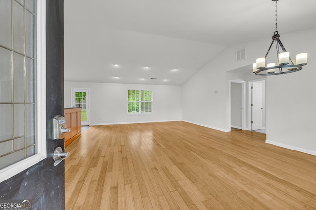 464 Old Camp Creek Rd, Cornelia, GA 30531 - unfurnished living room featuring a chandelier, light wood-type flooring, vaulted ceiling, and baseboards