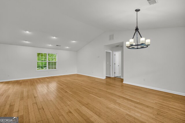 464 Old Camp Creek Rd, Cornelia, GA 30531 - spare room with a chandelier, light wood-style flooring, lofted ceiling, and baseboards
