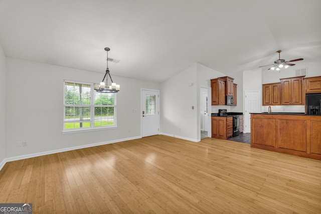 464 Old Camp Creek Rd, Cornelia, GA 30531 - unfurnished living room featuring vaulted ceiling, a chandelier, light wood-style flooring, and baseboards