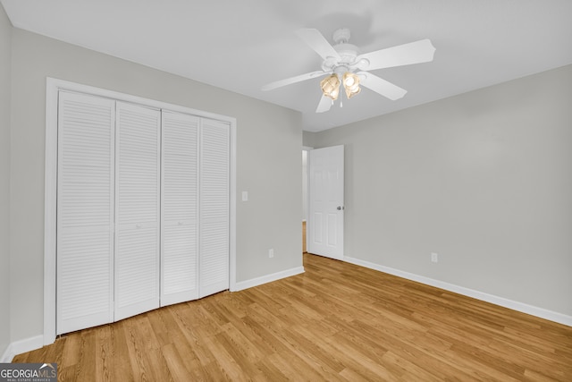 464 Old Camp Creek Rd, Cornelia, GA 30531 - unfurnished bedroom featuring light wood finished floors, baseboards, a closet, and a ceiling fan