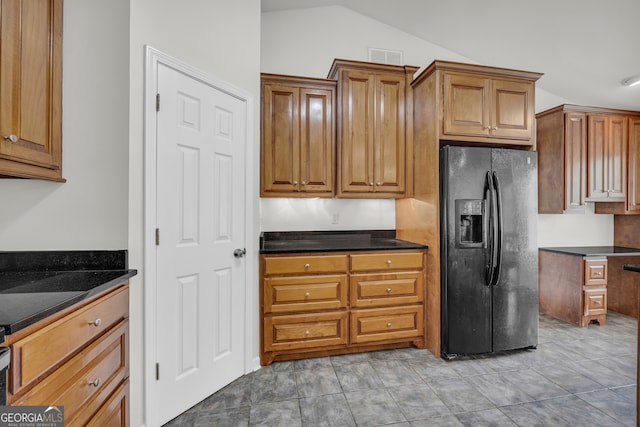 464 Old Camp Creek Rd, Cornelia, GA 30531 - kitchen featuring black fridge with ice dispenser, dark countertops, lofted ceiling, and brown cabinetry