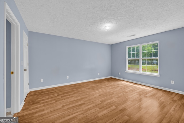 464 Old Camp Creek Rd, Cornelia, GA 30531 - unfurnished bedroom featuring a textured ceiling, wood finished floors, and baseboards