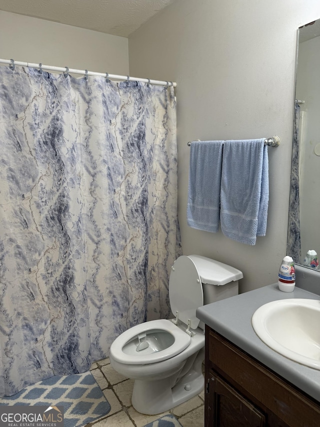 1432 Eagles Nest Cir, Carrollton, GA 30116 - full bath with vanity, toilet, a shower with shower curtain, and tile patterned flooring