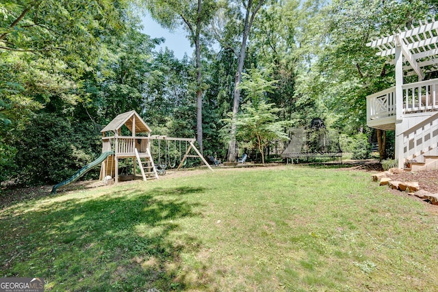 1448 Diamond Head Cir, Decatur, GA 30033 - view of green lawn featuring a trampoline, a playground, view of scattered trees, a deck, and stairway