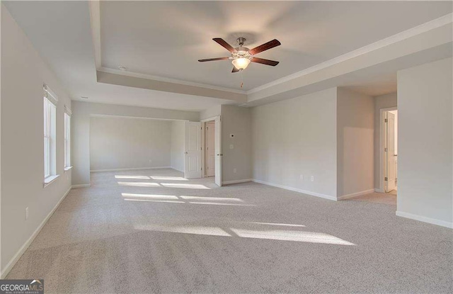 2525 Dixon Pl, Lawrenceville, GA 30045 - empty room featuring a raised ceiling, ceiling fan, light carpet, baseboards, and ornamental molding