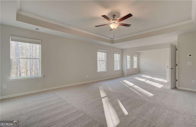 2525 Dixon Pl, Lawrenceville, GA 30045 - empty room with a tray ceiling, crown molding, a ceiling fan, baseboards, and light carpet