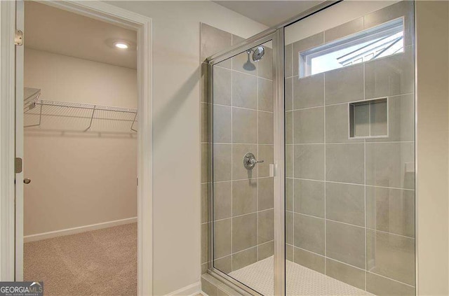 2525 Dixon Pl, Lawrenceville, GA 30045 - bathroom featuring a stall shower, a walk in closet, and baseboards