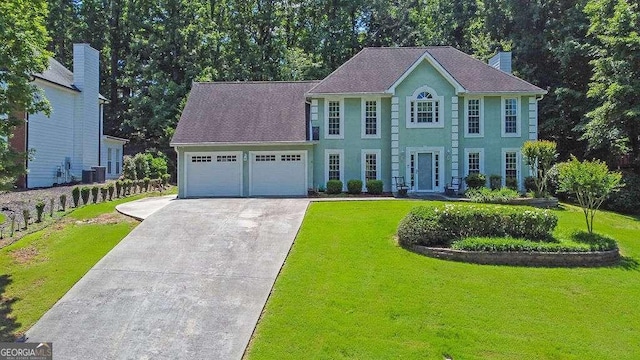 985 Laurel Springs Ln, Marietta, GA 30064 - colonial house featuring driveway, an attached garage, a front yard, and stucco siding