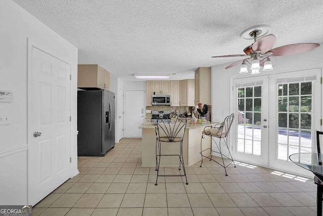 985 Laurel Springs Ln, Marietta, GA 30064 - kitchen with appliances with stainless steel finishes, ceiling fan, french doors, a textured ceiling, and a peninsula