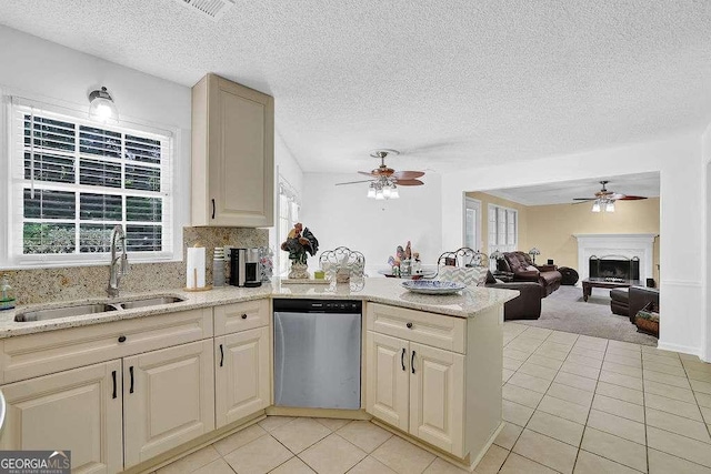 985 Laurel Springs Ln, Marietta, GA 30064 - kitchen with stainless steel dishwasher, a fireplace with raised hearth, a ceiling fan, light tile patterned flooring, and a textured ceiling