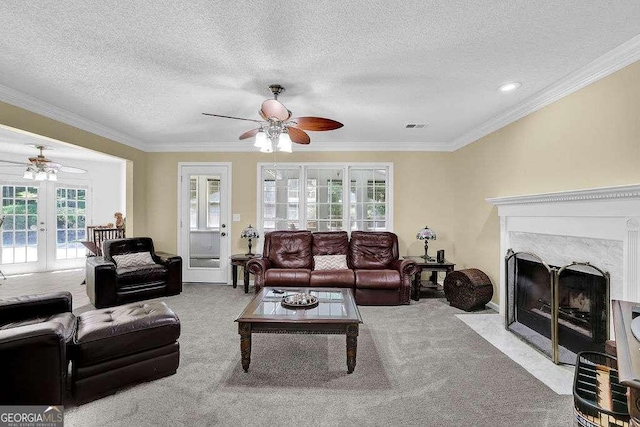 985 Laurel Springs Ln, Marietta, GA 30064 - carpeted living room featuring ceiling fan, french doors, a textured ceiling, ornamental molding, and a fireplace