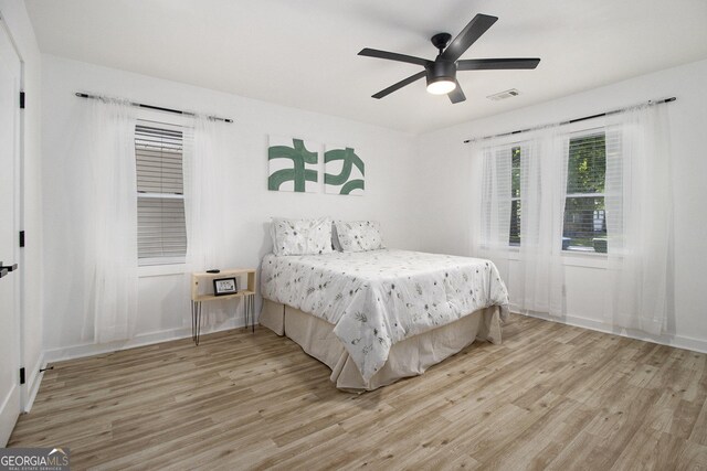 2537 Baker Rd NW, Atlanta, GA 30318 - bedroom featuring light wood-type flooring, a ceiling fan, and baseboards