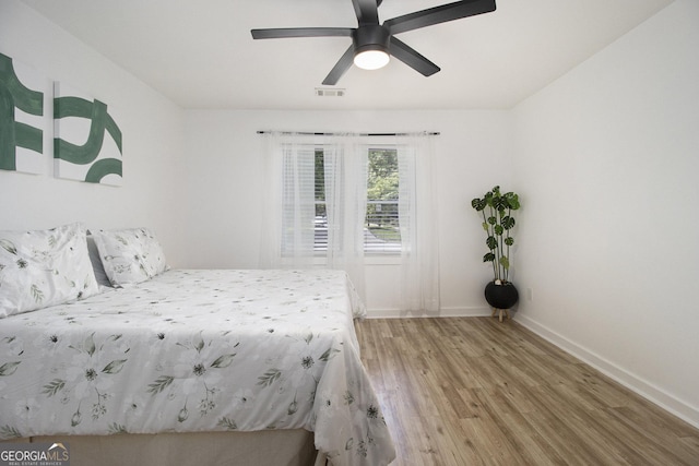2537 Baker Rd NW, Atlanta, GA 30318 - bedroom with light wood-style flooring, baseboards, and a ceiling fan