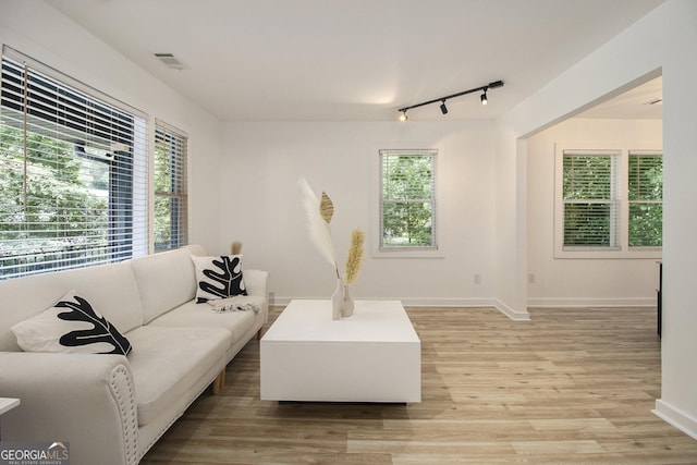 2537 Baker Rd NW, Atlanta, GA 30318 - living area featuring track lighting, light wood-type flooring, and baseboards