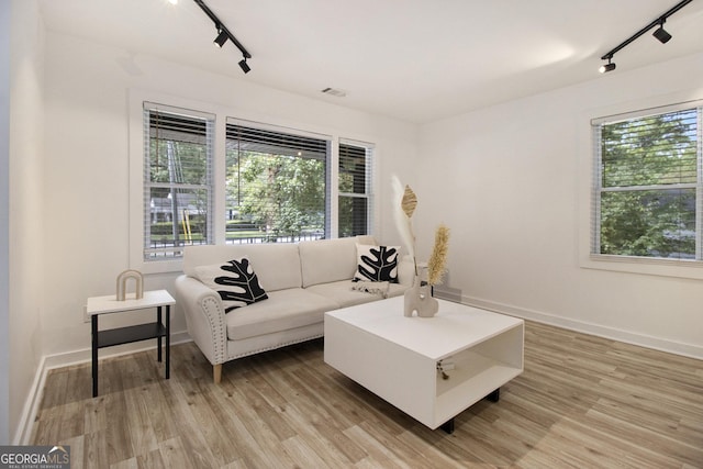 2537 Baker Rd NW, Atlanta, GA 30318 - living area with rail lighting, light wood finished floors, and baseboards