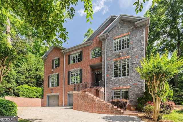 576 Cliftwood Ct, Sandy Springs, GA 30328 - view of front facade featuring stone siding, an attached garage, concrete driveway, and brick siding
