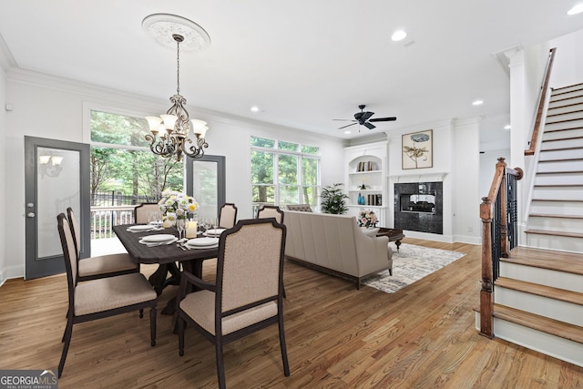 576 Cliftwood Ct, Sandy Springs, GA 30328 - dining space with stairs, ornamental molding, plenty of natural light, a fireplace, and a ceiling fan