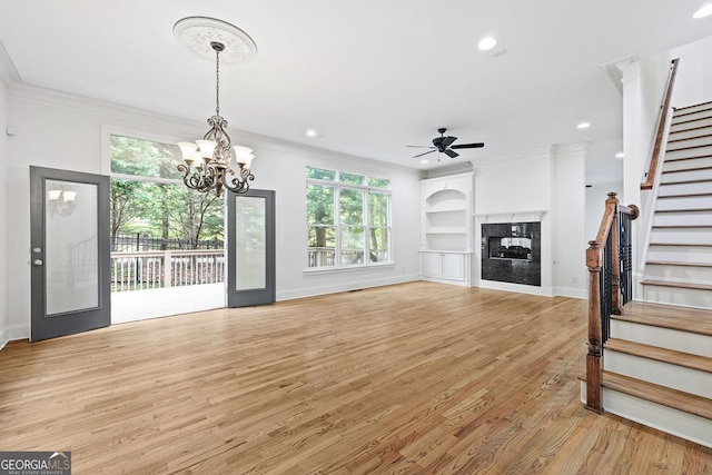 576 Cliftwood Ct, Sandy Springs, GA 30328 - unfurnished living room with stairs, light wood-type flooring, a ceiling fan, ornamental molding, and healthy amount of natural light