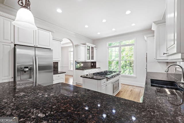 576 Cliftwood Ct, Sandy Springs, GA 30328 - kitchen with appliances with stainless steel finishes, arched walkways, backsplash, healthy amount of natural light, and ornamental molding