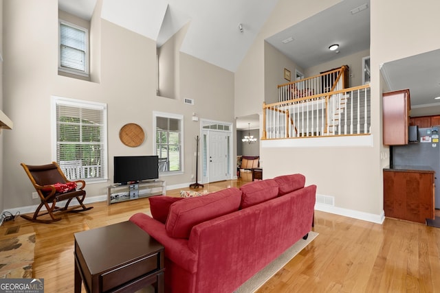 541 Brown Dr, Clermont, GA 30527 - living area featuring light wood-style flooring, baseboards, and a towering ceiling