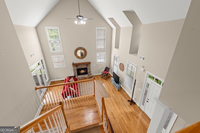 541 Brown Dr, Clermont, GA 30527 - living room with a high ceiling, wood finished floors, a ceiling fan, a fireplace, and baseboards