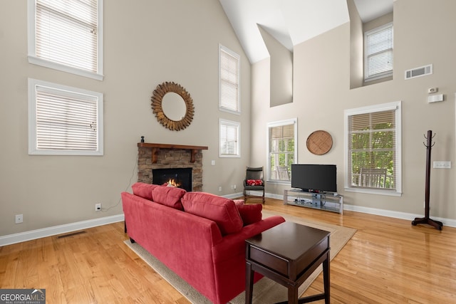 541 Brown Dr, Clermont, GA 30527 - living room featuring high vaulted ceiling, wood finished floors, a fireplace, and baseboards
