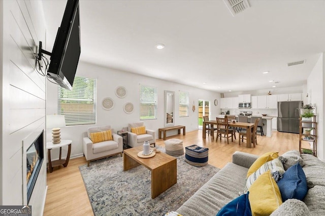 218 Lookout Dr, Dallas, GA 30132 - living area featuring light wood finished floors, recessed lighting, and a glass covered fireplace