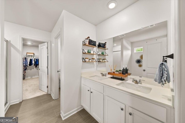 218 Lookout Dr, Dallas, GA 30132 - bathroom featuring double vanity and a walk in closet