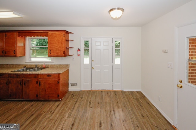 205 Northcrest Dr, Athens, GA 30601 - kitchen featuring a sink, light wood-style flooring, open shelves, and light countertops