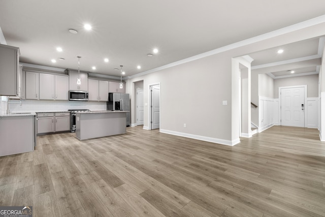 272 Broadstone Blvd, Acworth, GA 30101 - kitchen with appliances with stainless steel finishes, gray cabinetry, a kitchen island, open floor plan, and ornamental molding