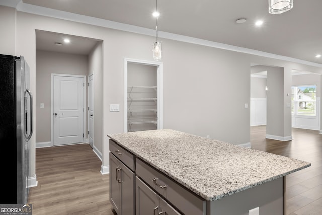 272 Broadstone Blvd, Acworth, GA 30101 - kitchen with freestanding refrigerator, gray cabinets, light wood-style flooring, light stone counters, and recessed lighting