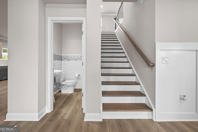272 Broadstone Blvd, Acworth, GA 30101 - staircase with wood finished floors, wainscoting, tile walls, and baseboards